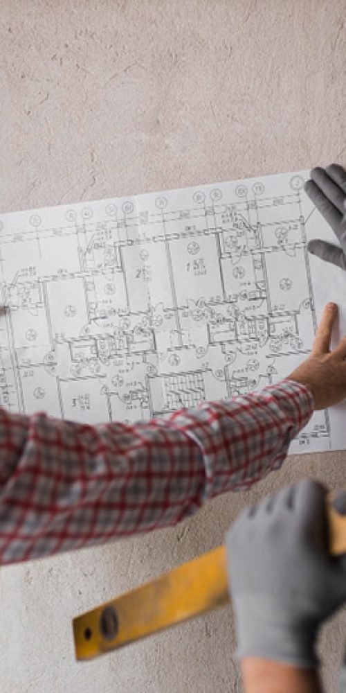 Engineers men looking at the building plan MEP Design